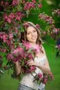 Young spring fashion woman in spring garden Springtime Summertime Trendy girl in the flowering trees in then at sunset in spring Royalty Free Stock Photo