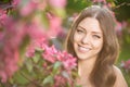 Young spring fashion woman in spring garden Springtime Summertime Trendy girl in the flowering trees in then at sunset in spring