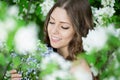 Young spring fashion woman in spring garden Springtime Summertime Trendy girl in the flowering trees in then at sunset in spring Royalty Free Stock Photo