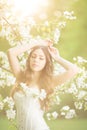 Young spring fashion woman in spring garden Springtime Summertime Trendy girl in the flowering trees in the spring summer garden Royalty Free Stock Photo