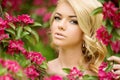 Young spring fashion woman. Trendy girl in the flowering trees i Royalty Free Stock Photo