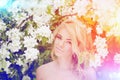 Young spring fashion woman. Trendy girl in the flowering trees i Royalty Free Stock Photo