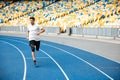 Young sprinter running on athletics track