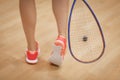 A young squash player hiting a ball in a squash court Royalty Free Stock Photo