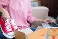 start up small business owner packing shoes in the box at workplace. freelance woman entrepreneur SME seller prepare product for Royalty Free Stock Photo
