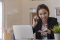 Young startup business professional talking to a client on his cellphone.