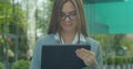 Young Startup Businesswoman using digital tablet. Beautiful woman in Glasses texting Messages, cheating on her digital Royalty Free Stock Photo