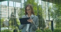 Young Startup Businesswoman using digital tablet. Beautiful woman in Glasses texting Messages, cheating on her digital Royalty Free Stock Photo