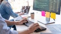 Young startup Programmers Sitting At Desks Working On Computers screen for Developing programming and coding to find solution to Royalty Free Stock Photo
