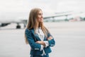 Young stewardess in uniform on aircraft parking