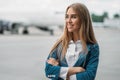 Young stewardess in uniform on aircraft parking