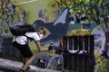 Young street artist at work with a spray paint can to paint murals Royalty Free Stock Photo
