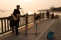 A young street musician singing along the beach in Xiamen city, China