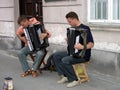 Young street musicians playing accordions