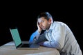 Young stressed businessman working on desk with computer laptop in frustration and depression Royalty Free Stock Photo