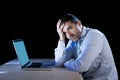 Young stressed businessman working on desk with computer laptop in frustration and depression Royalty Free Stock Photo