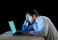 Young stressed businessman working on desk with computer laptop in frustration and depression Royalty Free Stock Photo