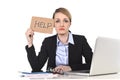 Young stressed businesswoman holding help sign overworked at off Royalty Free Stock Photo