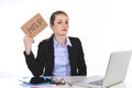 Young stressed businesswoman holding help sign overworked at office computer Royalty Free Stock Photo