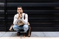 Young stressed and depressed businessman squat down outside office building waiting for job interview results. Working man feeling Royalty Free Stock Photo