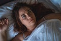 Young stressed or depressed woman lies in bed, can not sleep. Insomnia concept, top view Royalty Free Stock Photo