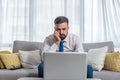 Young stressed freelancer expert business man in shirt and necktie looking at his laptop computer screen reading negative charts a