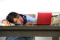 Young stressed and frustrated Asian Korean teenager student working with textbooks and laptop computer on desk overwhelmed and Royalty Free Stock Photo