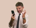 Young stressed and upset businessman in shirt and necktie working using mobile phone checking online business overwhelmed and Royalty Free Stock Photo