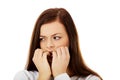 Young stressed woman biting her nails