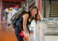 Young stressed and worried Asian Chinese woman at airport tired and sad missing flight or suffering delay on holidays travel in Royalty Free Stock Photo