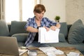 Desperate woman banking and accounting home monthly and credit card expenses with computer laptop doing paperwork Royalty Free Stock Photo