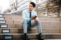 Young Striving Asian Businessman Sitting on Staircase in the City