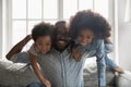 Young strong african american daddy carrying laughing kids. Royalty Free Stock Photo