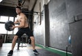 Young strong fit muscular man doing throwing medicine ball up on the wall for crossfit training hard core workout in gym Royalty Free Stock Photo