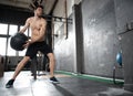 Young strong fit muscular man doing throwing medicine ball up on the wall for crossfit training hard core workout in gym Royalty Free Stock Photo