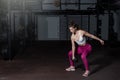 Young strong fit muscular sweaty girl with big muscles strength cross workout training with dumbbells weights in the gym dark imag Royalty Free Stock Photo