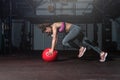 Young strong fit sweaty muscular girl with big muscles doing push ups and running for hard core crossfit strength workout training Royalty Free Stock Photo