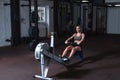 Young strong fit sweaty powerful attractive muscular woman with big muscles doing hard core row heavy cross training workout on in Royalty Free Stock Photo