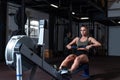 Young strong fit sweaty powerful attractive muscular woman with big muscles doing hard core row heavy cross training workout on in Royalty Free Stock Photo