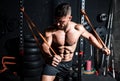 Young strong focused fit muscular man chest stretching workout in improvised gym with rubber for strength and good looking of musc Royalty Free Stock Photo