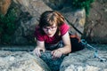 Young slender climber climbs a rock Royalty Free Stock Photo