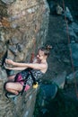 Young slender climber climbs a rock Royalty Free Stock Photo