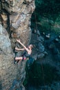 Young slender climber climbs a rock Royalty Free Stock Photo