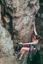 Young slender climber climbs a rock Royalty Free Stock Photo