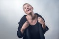 Young, strong, laughing woman with very short blond hair