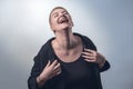 Young, strong, laughing woman with very short blond hair