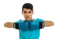 Young strong man in blue shirt practicing boxing in gloves isolated on white background Royalty Free Stock Photo