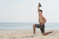 Young strong man doing lunges with kettle bell. Royalty Free Stock Photo