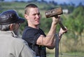 Young strong man fencing country property