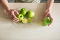 Young strong man having light breakfast.Apple juice in the kitchen. Fresh fruits and healthy food Royalty Free Stock Photo